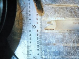 Laser TIG welding repair on a part. Ruler shown for scale